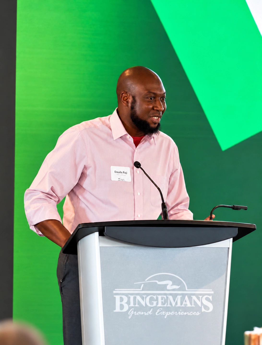 Dauda Raji addressing an audience from a podium