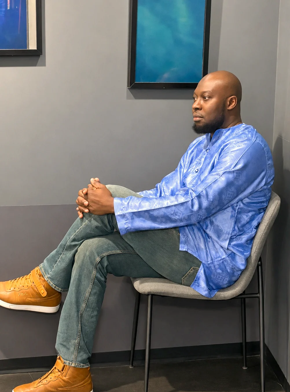 Dauda Raji seated in a thoughtful conversation